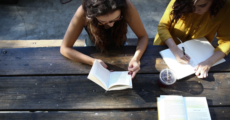 Personen sitzen über Büchern