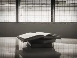 Books on a table in a prison.
