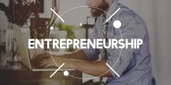 Entrepreneurship written over image of a man on a laptop Entrepreneurship written over image of a man on a laptop.