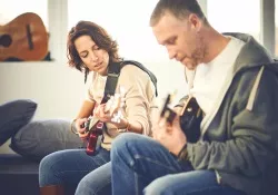 Learning to play the guitar Learning to play the guitar .