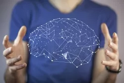 Man with hands held out beside image of a virtual brain Man with hands held out beside image of a virtual brain.